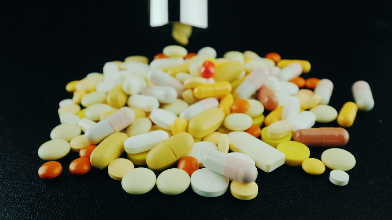 Hands Move A Bunch Of Pills And Capsules