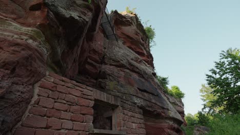 tilt up above brick house wall concrete cemented into mountain cliff side