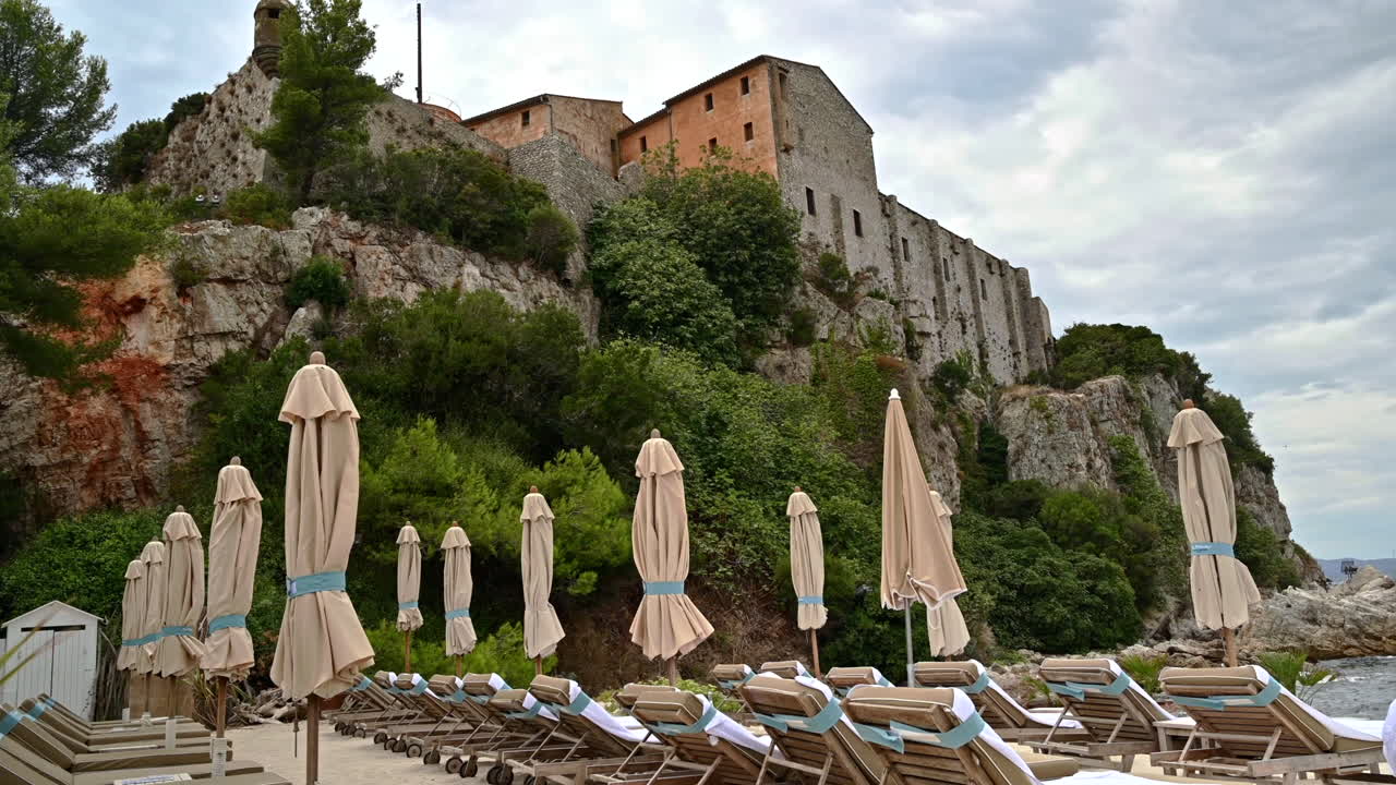 View of the Mediterranean sea coast on the Island of Sainte-Marguerite, beach, castle on the rocks, a lot of greenery, France