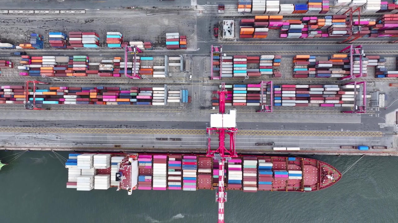 At a bustling cargo port, massive container ships dock alongside colorful shipping containers. This dynamic setting highlights maritime logistics and the heartbeat of global trade.