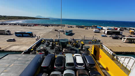 Cars-loaded-on-a-ferry-at-the-bustling-port-of-Zakynthos,-Greece-on-a-sunny-day