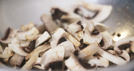 chef slicing mushrooms in kitchen 2