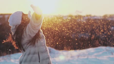 long-haired-lady-in-white-brown-fur-coat-throws-snow-up