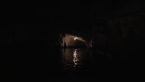 sailing in dark karst cave of ha long bay vietnam