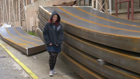 mysterious girl walking through an industrial place