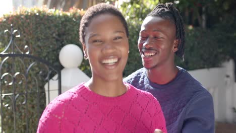 Portrait-of-happy-african-american-couple-embracing-in-sunny-garden,-slow-motion