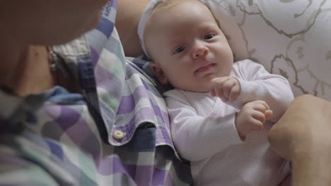 careful and loving grandpa with baby granddaughter