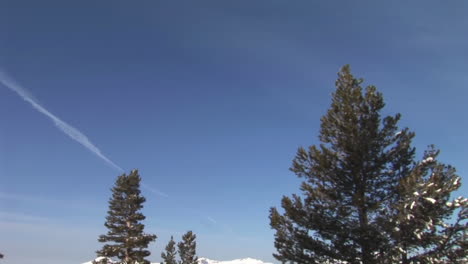 Panning-shot-from-snowy-mountains-to-a-camper