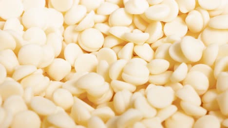 white chocolate chips cascading in a pile