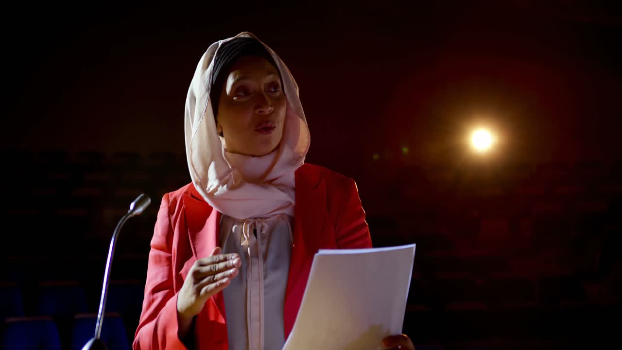 Businesswoman with hijab speaking in business seminar at auditorium 4k