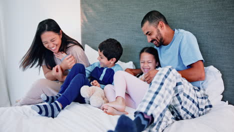 happy family playing in bed