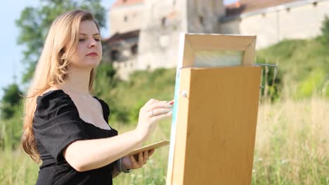 at sunlight young artist painting with oil paint picture on canvas hold brush and palette in light at sunlight young artist painting with oil paint picture on canvas hold brush and palette in light art studio workspace creative
