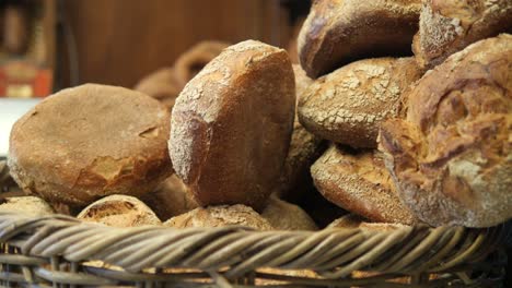 close-up of a basket full of fresh, brown bread loaves