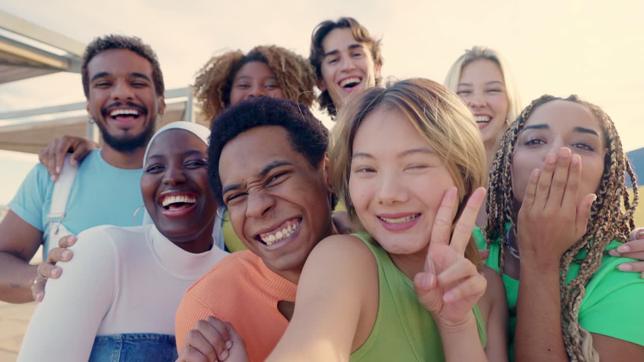 Chinese woman taking selfie with multi-ethnic friends outdoors