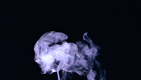 Rising-puff-of-smoke-on-black-background