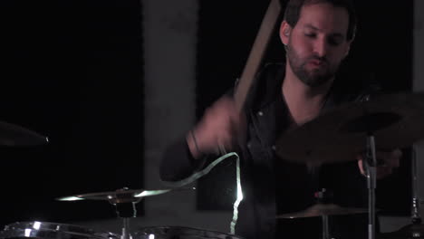 a close up of a young heavy metal drummer rehearsing his songs and doing some stick tricks