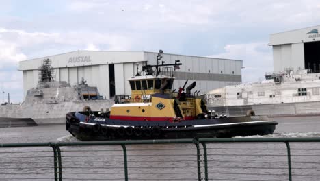 Yellow-and-red-tugboat-moving-in-Mobile-Bay-in-Mobile,-Alabama-with-stable-video-in-slow-motion