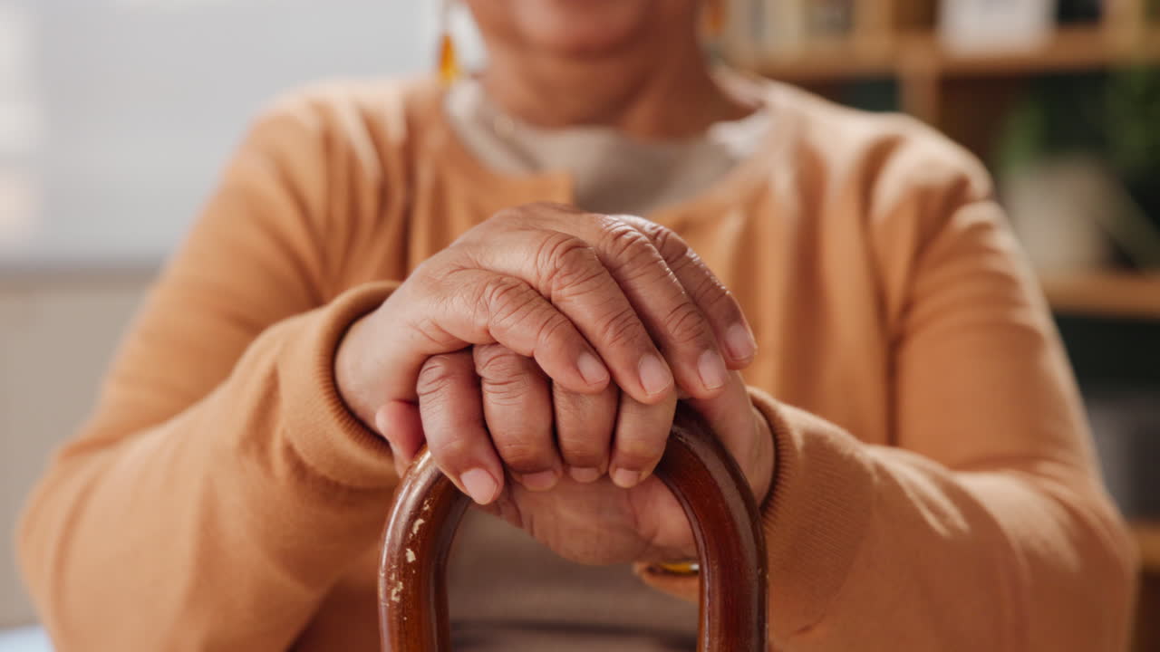 Close up of Senior Woman's Hands on Walking Stick