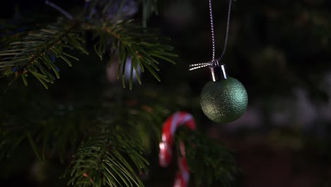 Christmas-bauble-hanging-on-a-decorated-tree-close-up