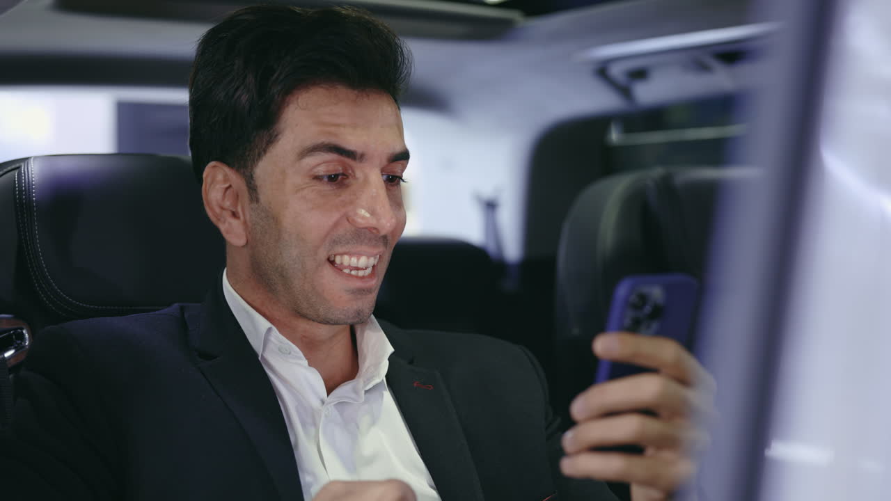 Businessman using phone in a car