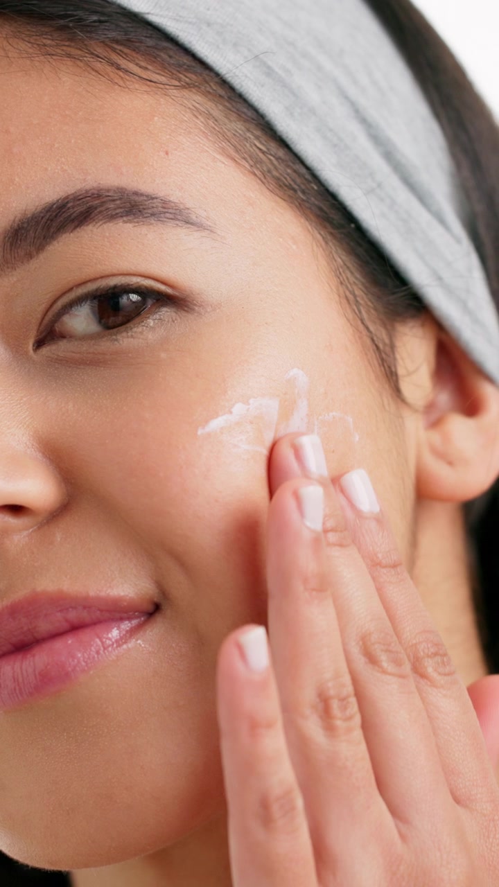 Young Woman Applying Sunscreen to Her Face