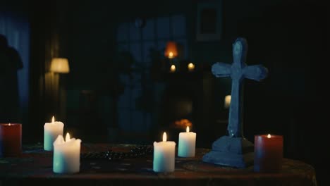 video capturing a table with magical tools on it a priest is sitting at the table with beads in his - video capturing a table with magical tools on it. a priest is sitting at the table with beads in his hands, praying with his eyes closed, when a hand lays on his shoulder. creative content, hallowee
