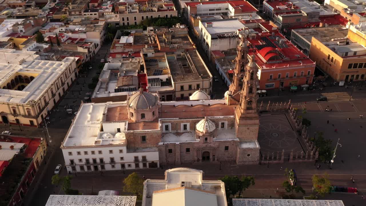 DRONE: ORBIT SHOT OF AGUASCALIENTES CATHEDRAL AT DOWNTOWN AGUASCALIENTES ON A SUNSET