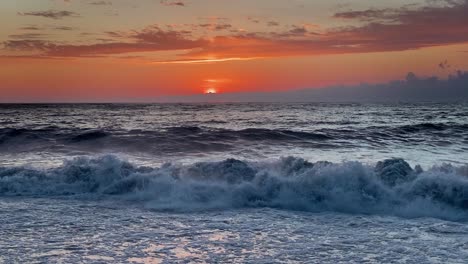 sea storm on the beach of black sea after colourful sunset