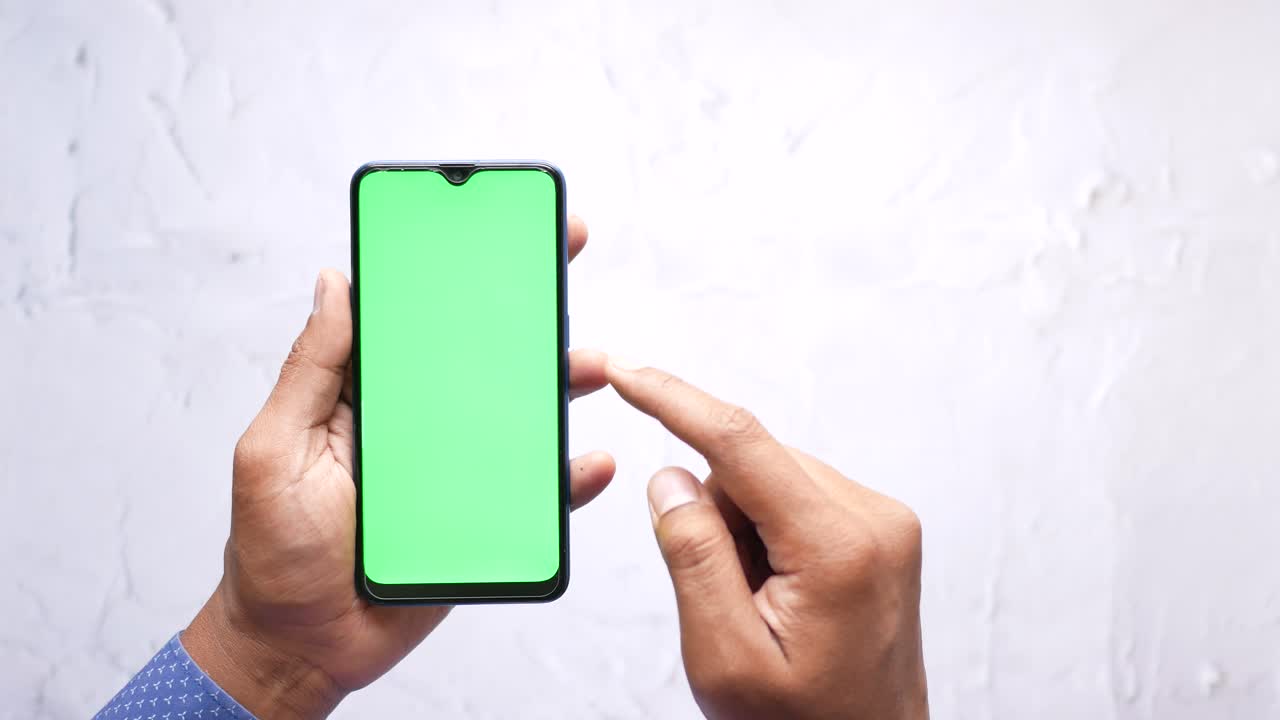 Person holding a smartphone with a green screen | Premium Stock Video ...