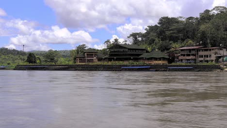 scenic cruise on the amazon river with view on a small village in peru, south america