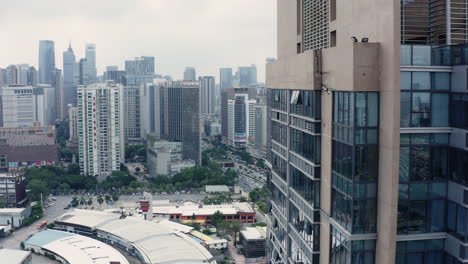 fly by near office buildings with view on guangzhou downtown office building area in background