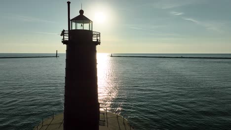 a small bay on the coast of michigan, guarded by a sturdy lighthouse