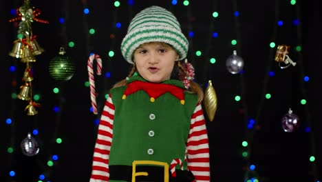 Displesed-kid-teenager-girl-in-elf-Santa-helper-costume-negative-emotions,-upset-on-Christmas-Eve