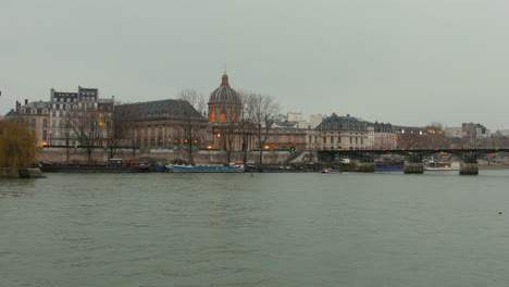 wide angle view of pont des arts with waterfront in paris, france