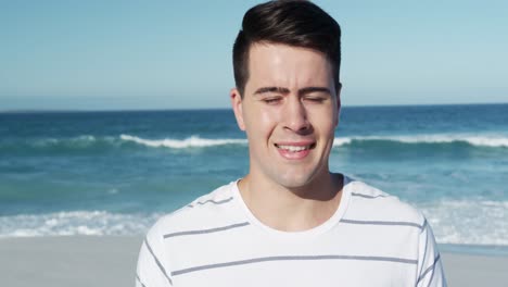 man standing on the beach and looking at camera