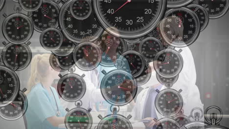 in healthcare setting, animation of multiple stopwatches overlaying people working