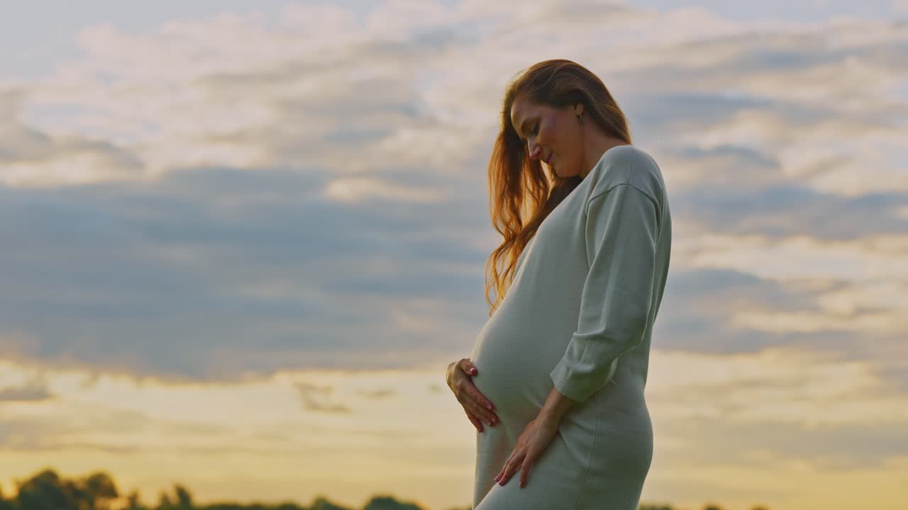 Pregnant woman enjoying a sunset