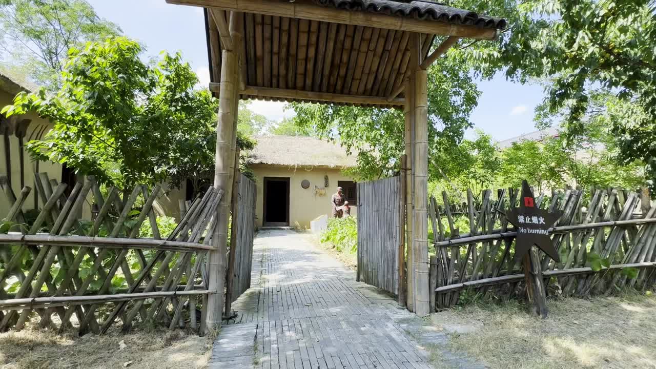 Entrance of bamboo leads a man to an old earthen compound in a quiet park in China
