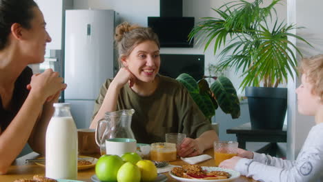 lgbtq family singing song on breakfast at home
