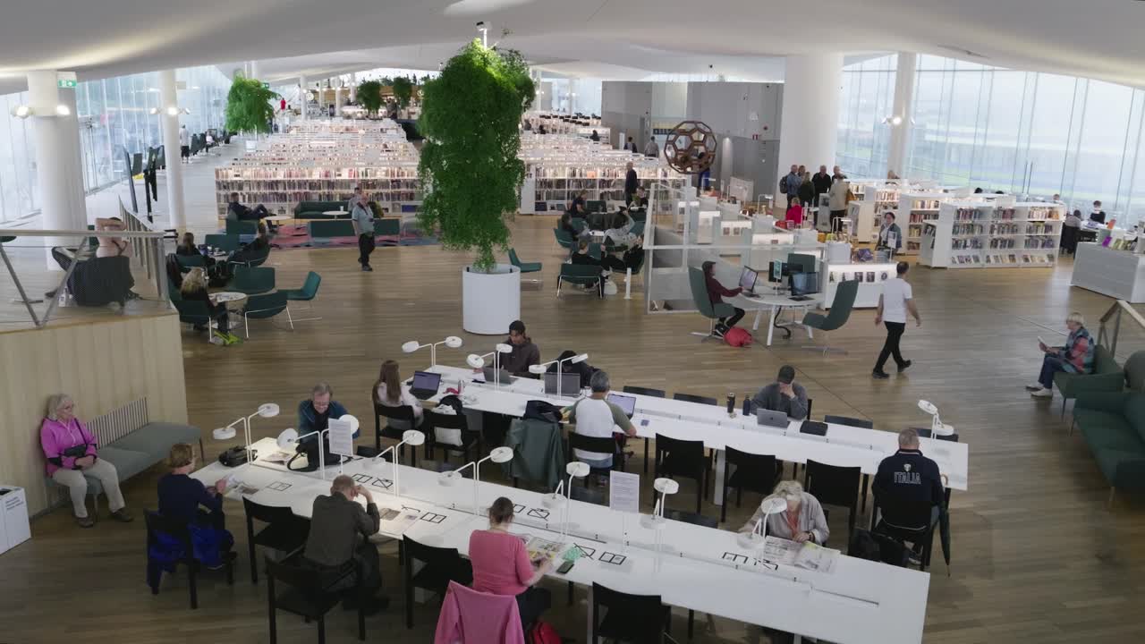 Modern public library in Helsinki, Finland with people studying
