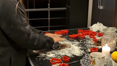 Making-sweet-gingerbread-cookies-for-Christmas-by-chef-on-festive-table