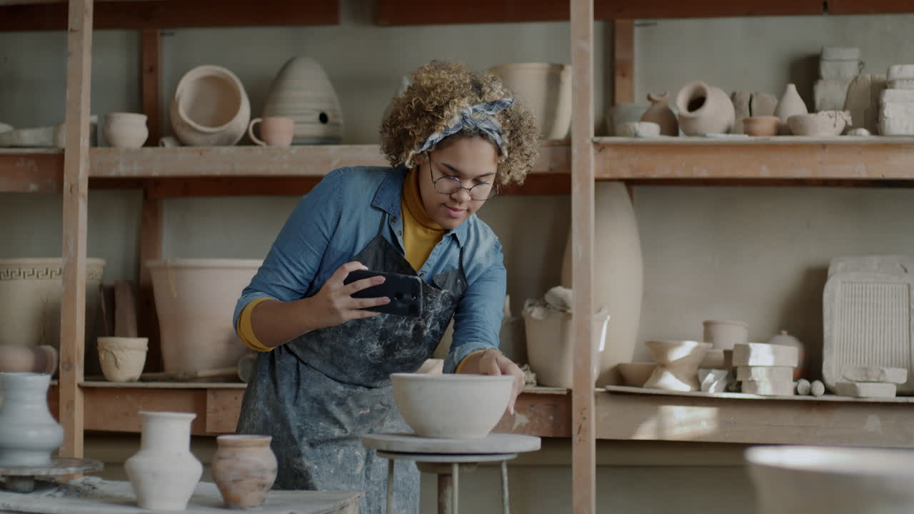 Woman Artist Working on Pottery in Studio