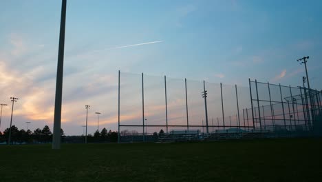 timelapse of twilight sky over baseball diamond, summer evening