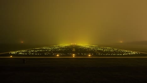mysterious fog-enshrouded runway with illuminated lights cutting through the dense mist, leading the way for incoming aircraft in the twilight