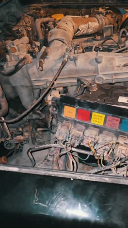 The-engine-and-fuse-box-of-a-90's-Nissan-Patrol-SUV-showcasing-its-vintage-mechanics