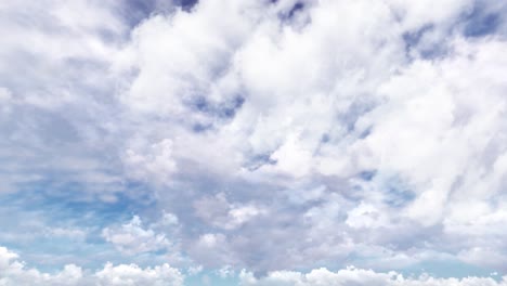 timelapse of thick white clouds in a blue sky