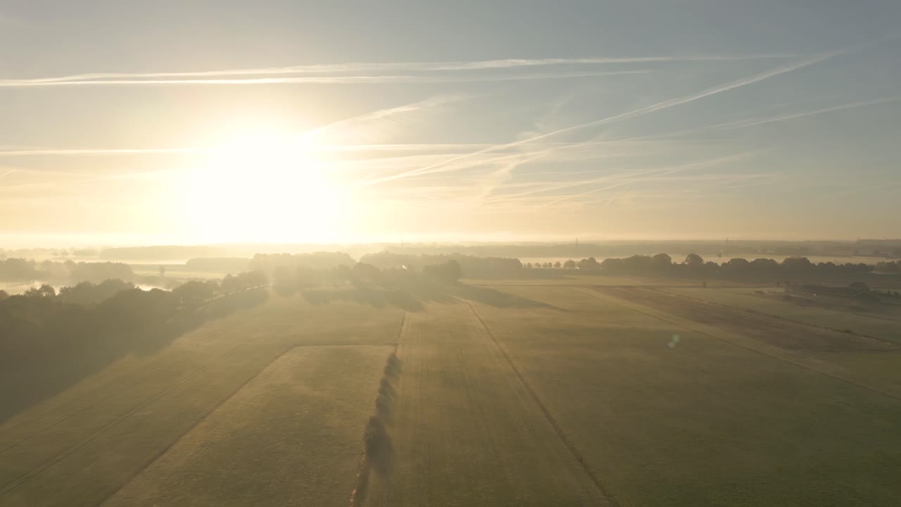 Sunrise over Misty Farmland