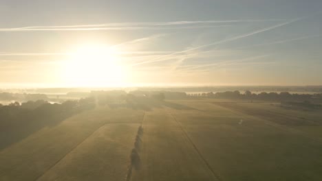 sunrise over misty farmland