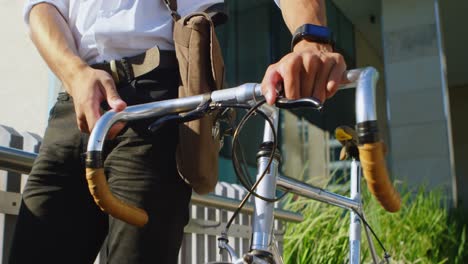 man walking along with the bicycle in city 4k