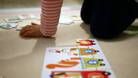 child playing with colorful puzzles with numbers learning to count